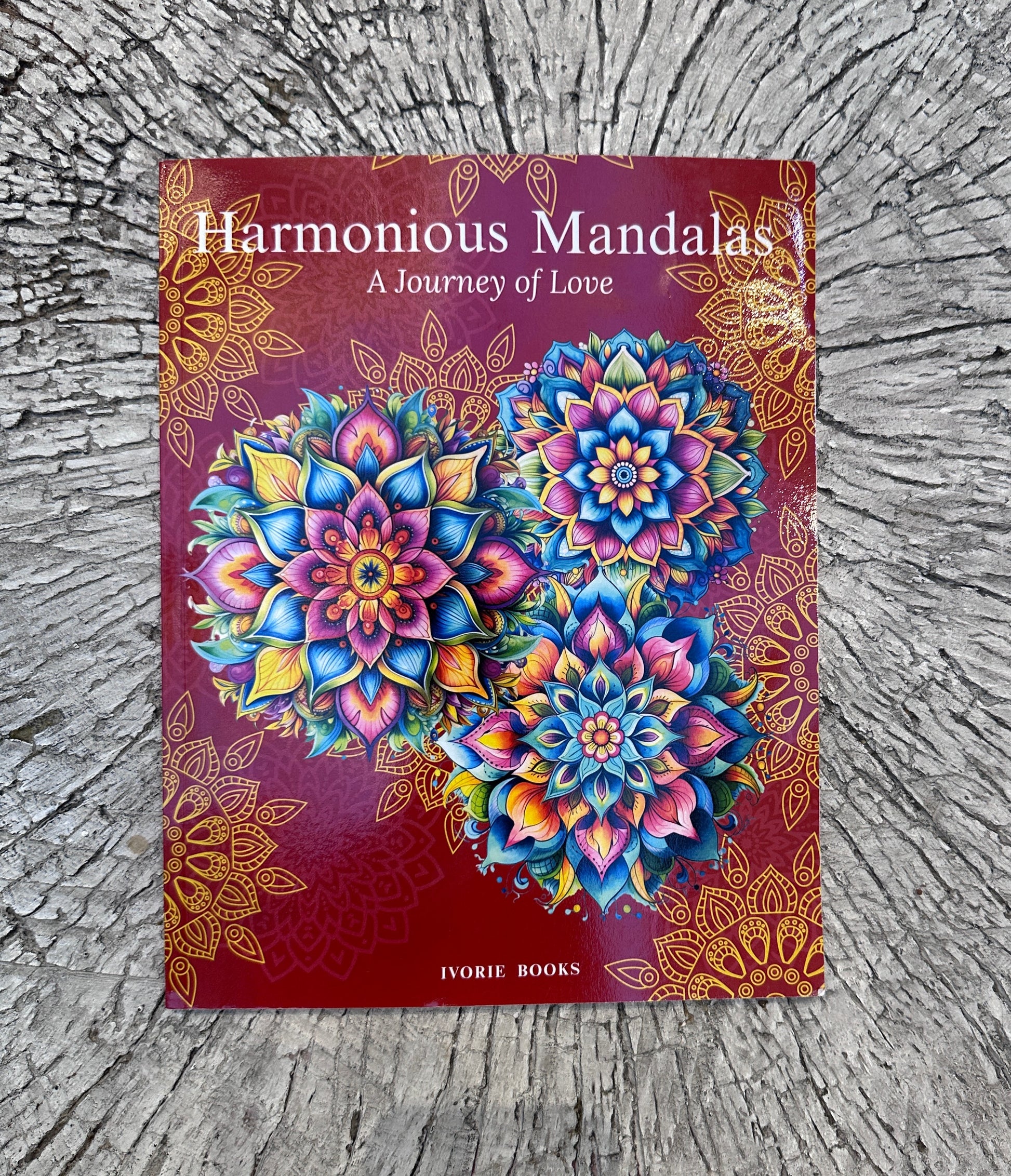 Real paperback photo of Harmonious Mandalas: A Journey of Love, showing the actual printed coloring book available from Ivorie Books.